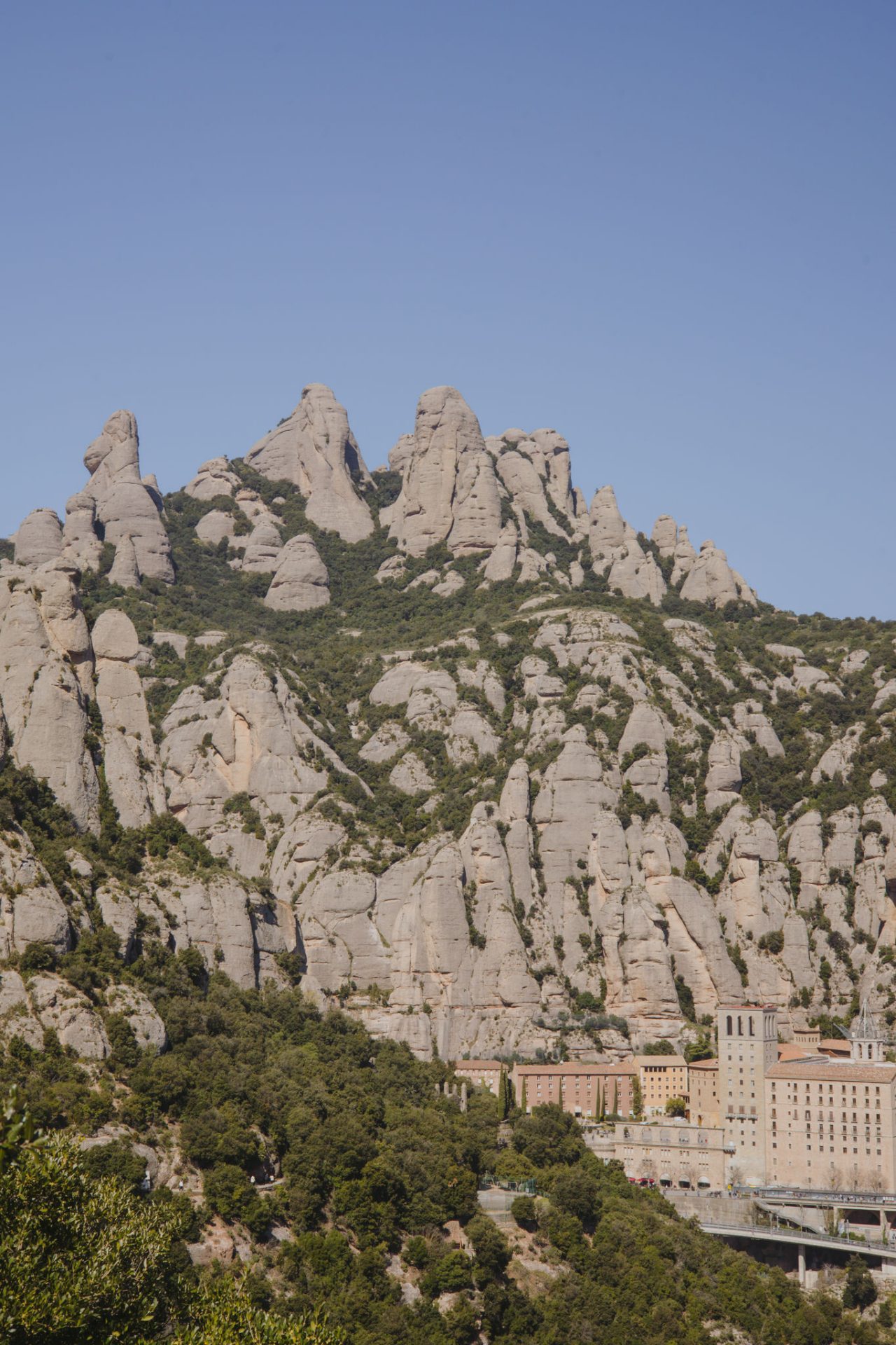 Vistes de la muntanya de Montserrat amb les seves formacions rocoses i el monestir al peu de la muntanya