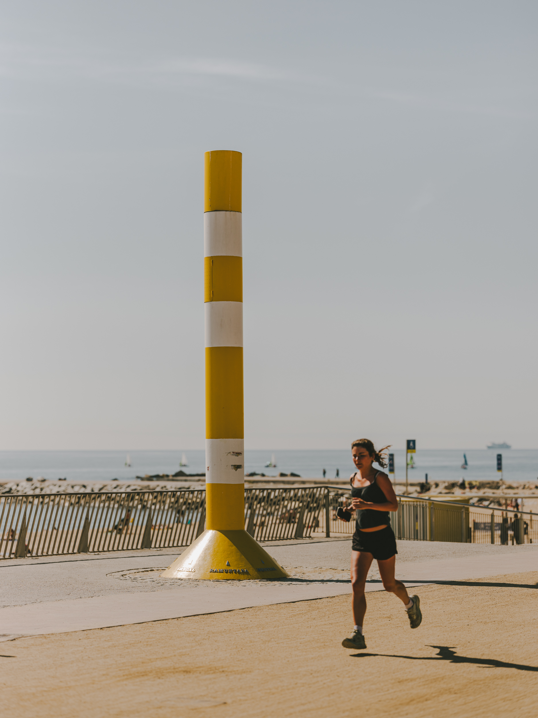 A woman runs along the seafront promenade.